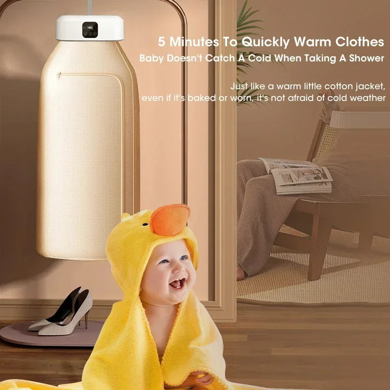 Baby wrapped in a yellow towel with duck design, standing in a bathroom with portable clothes dryer