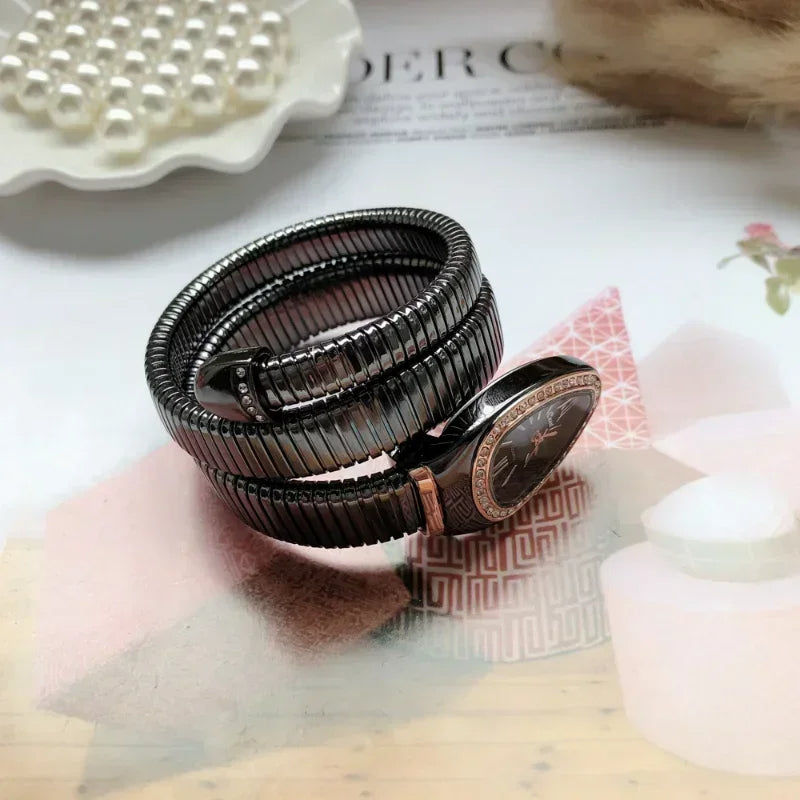 Black beaded bracelet on a textured surface with decorative elements