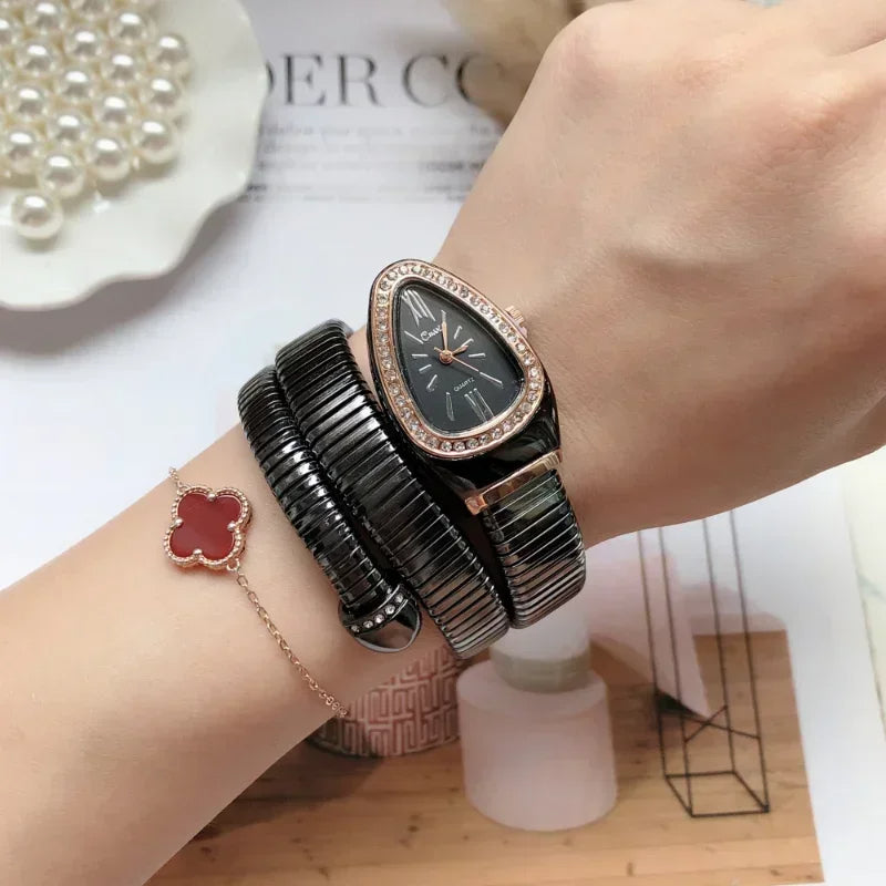 Person wearing a black watch with rose gold accents on a light background
