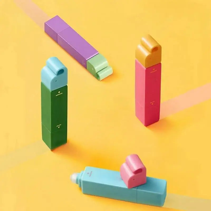 Colorful stain remover pens on a yellow background