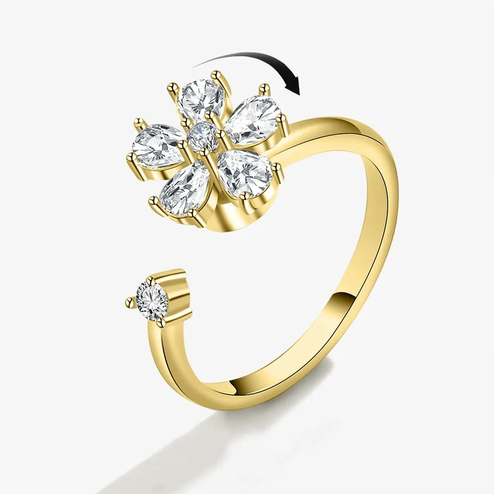 Gold ring with diamond-like stones on a white background