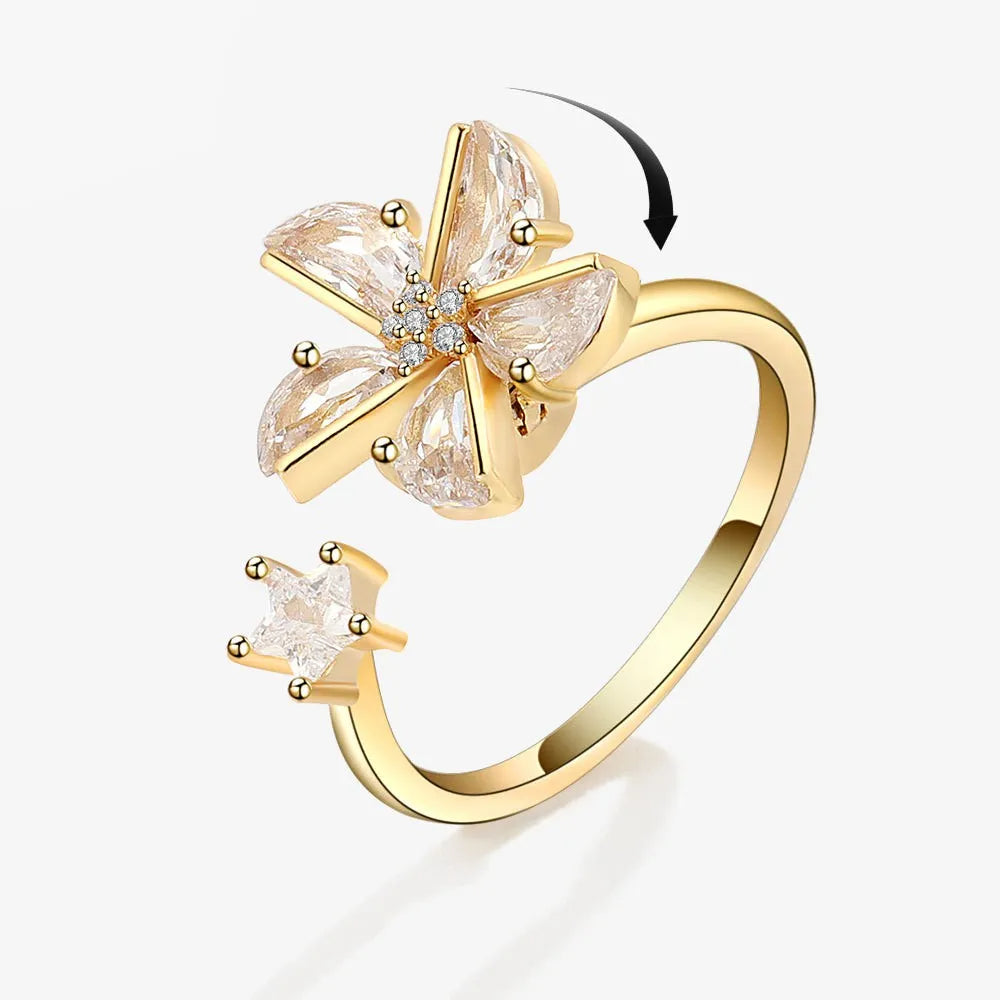 Gold ring with floral design on a white background