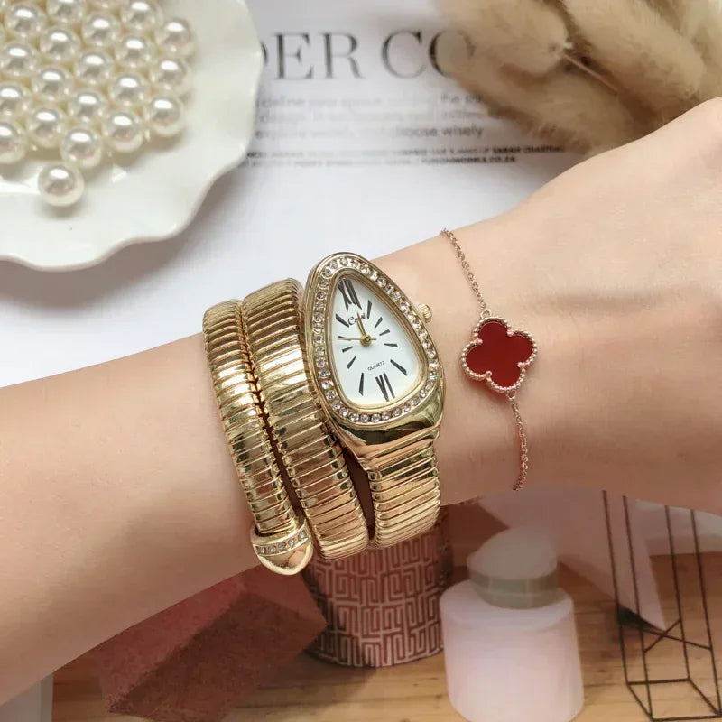 Gold watch and bracelet on a wrist with a decorative background