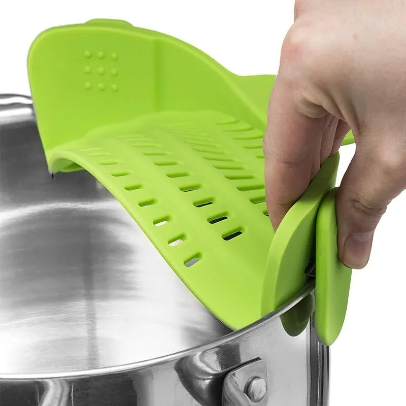 Green silicone pot holder being used on a metal pot