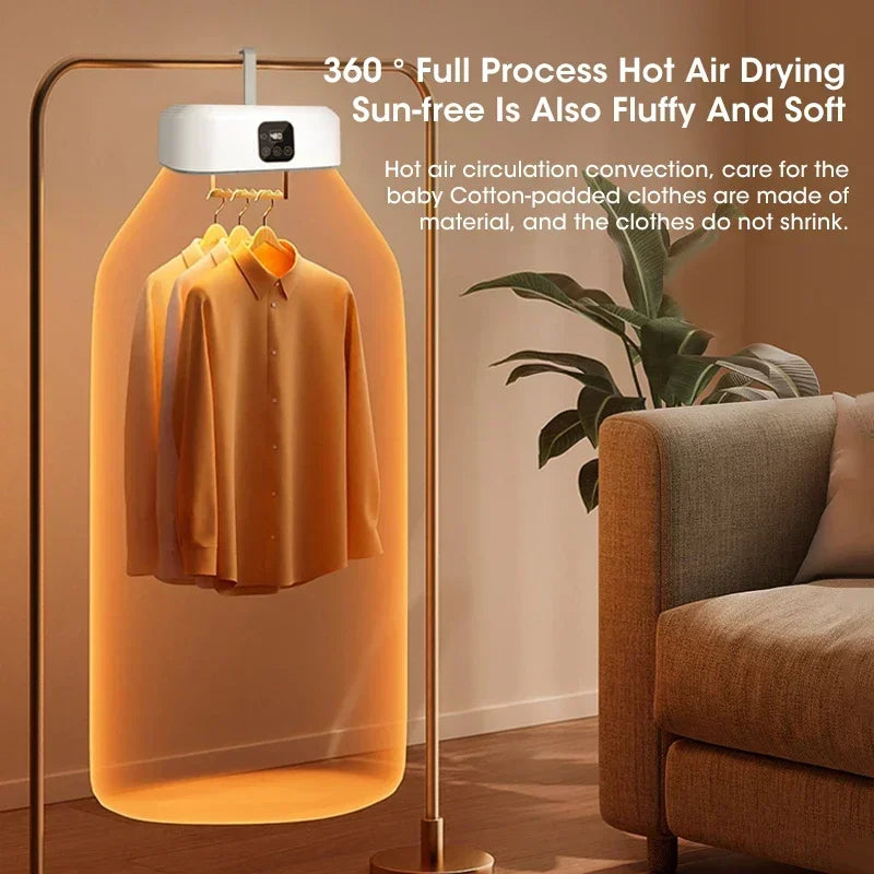 Hot air drying rack with clothes inside, placed in a room with a couch and plant.
