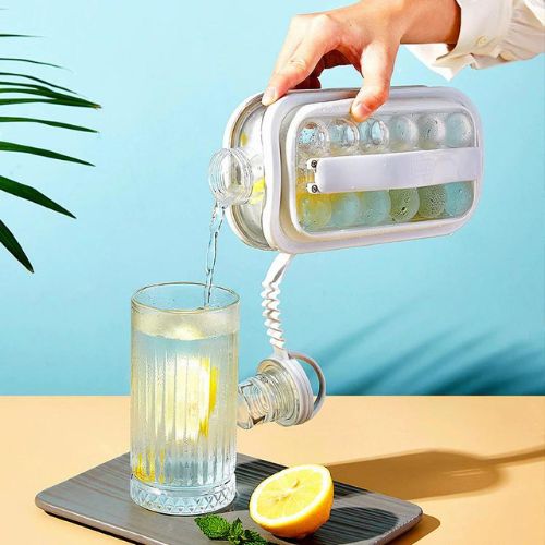 Hand pouring water from a novelty light into a glass with a lemon on a blue background