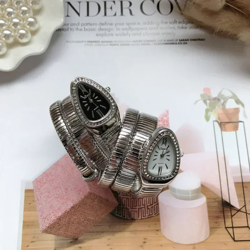 Silver bracelet with watch face design on a magazine page