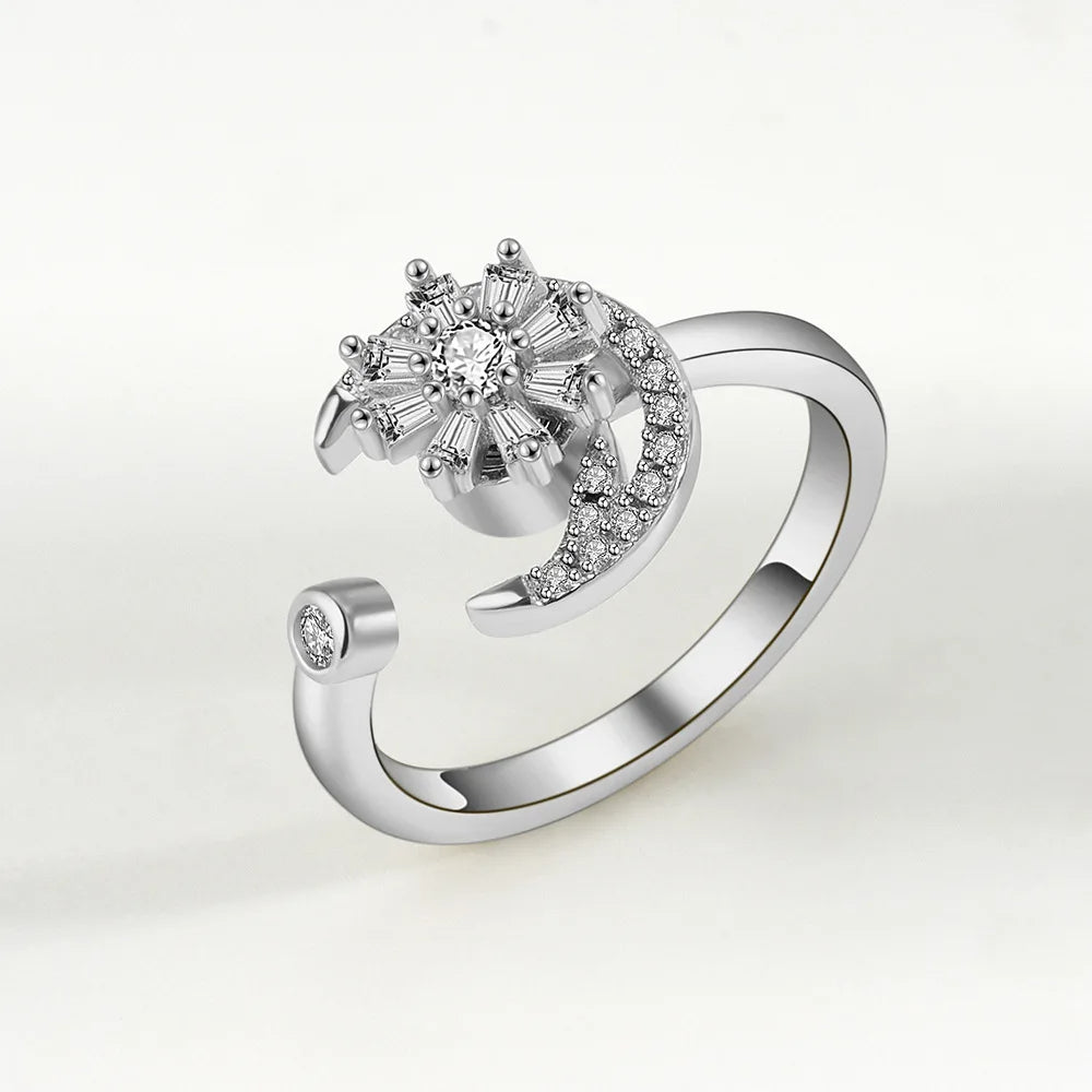 Silver ring with diamond accents on a light gray background