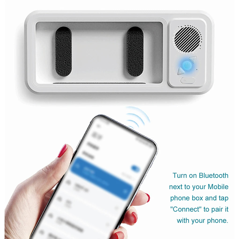 White shower phone holder device with Bluetooth connectivity feature, shown with a smartphone.