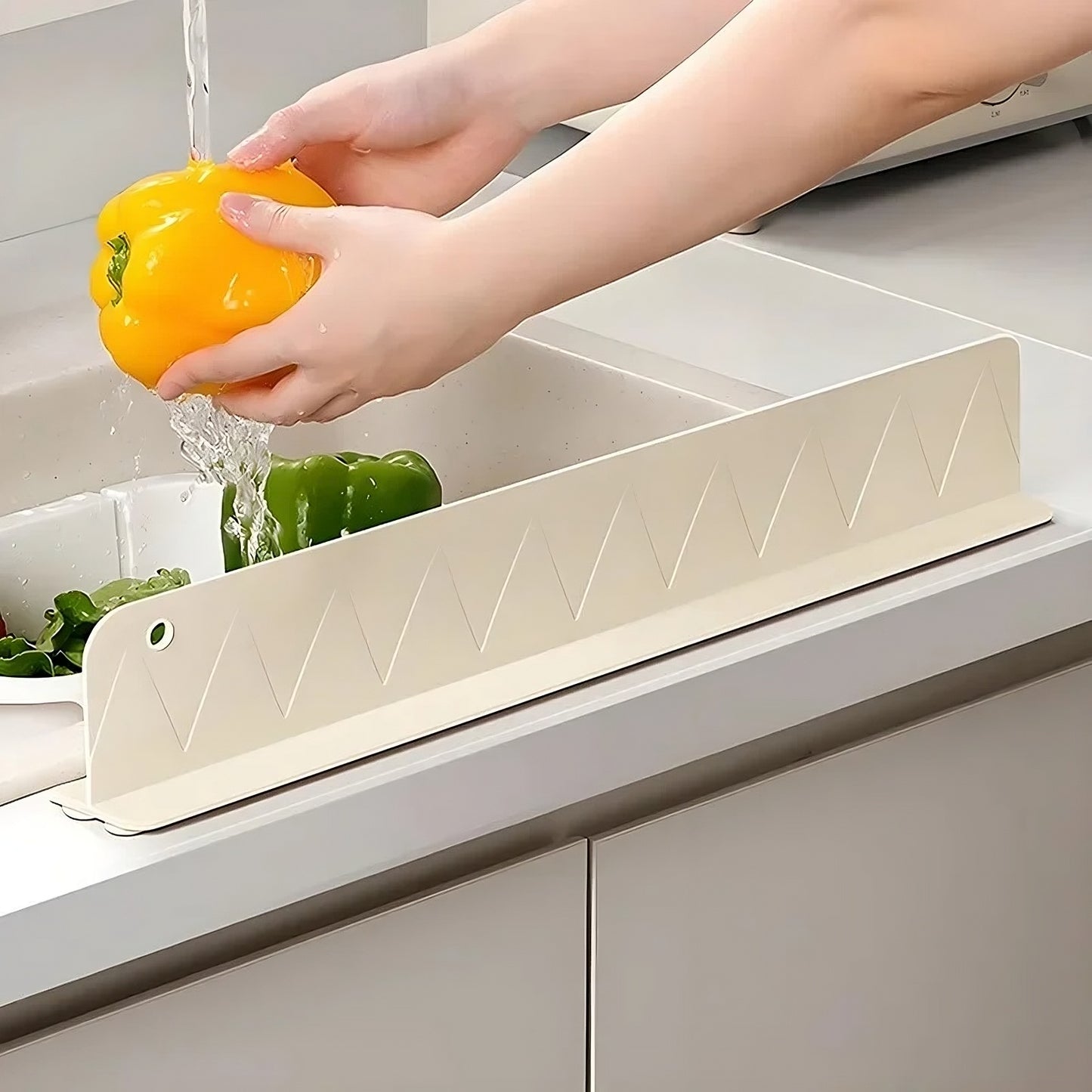 Person washing a yellow bell pepper over a white kitchen sink.
