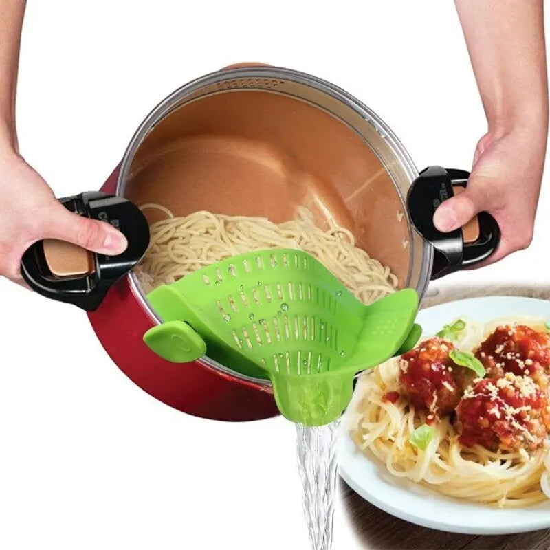 Person using a green kitchen tool to drain pasta from a pot, with a plate of spaghetti in the foreground.