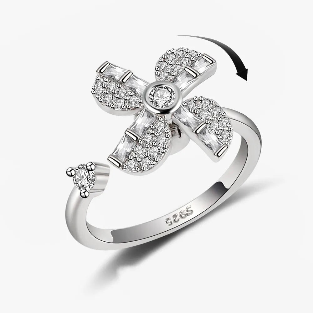 Silver ring with diamond accents on a white background