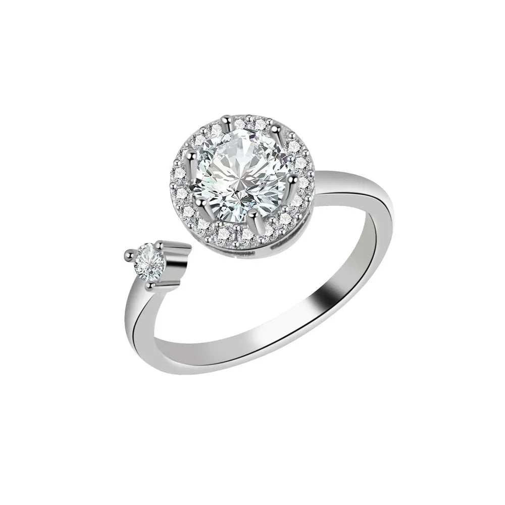 Silver ring with a large diamond and smaller diamond on a white background