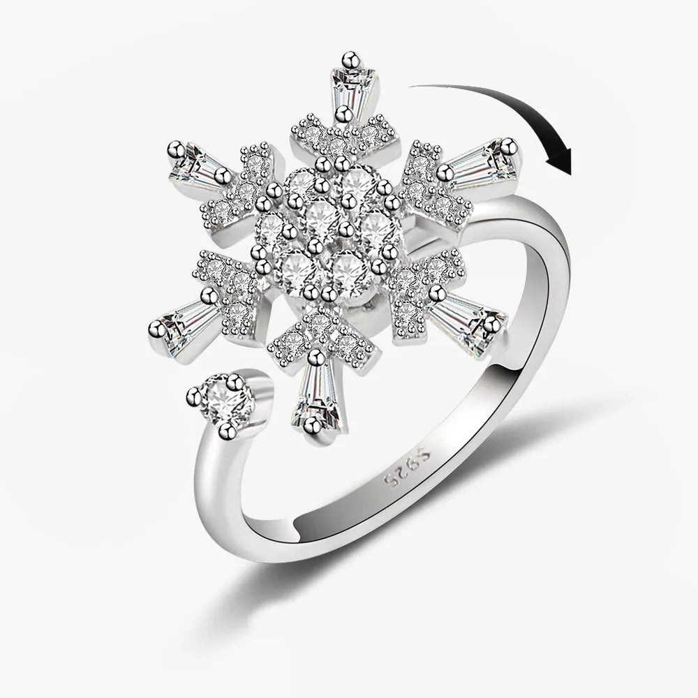 Silver snowflake ring with clear gemstones on a white background
